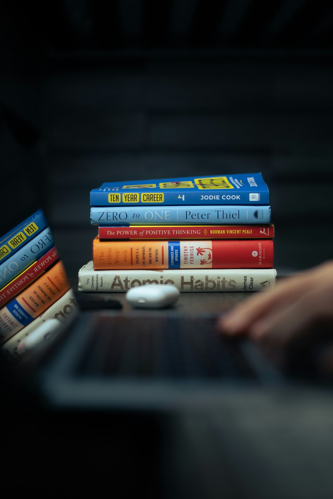 a-stack-of-books-sitting-on-top-of-a-laptop-computer-hh6dqo4b-xg
